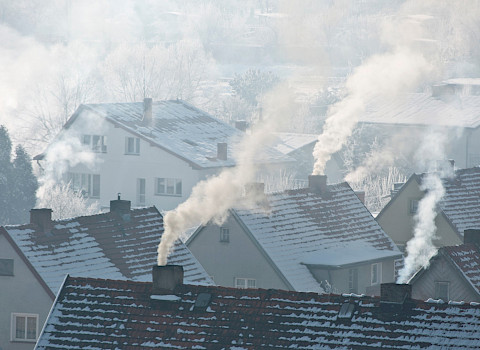 Soot arising from chimneys in residential area