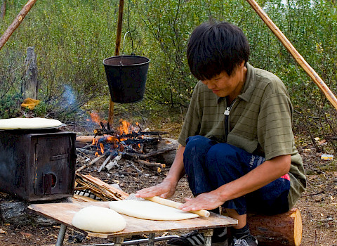 Evenki reindeer herder is making traditional Evenki bread – tupa. Neryungri District, Republic of Sakha (Yakutia), Russia. Credit: Yuri Kokovin