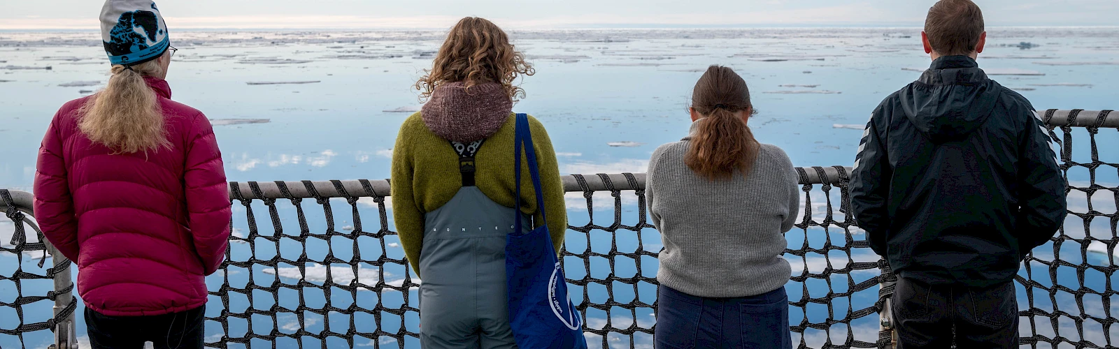 People on a ship enjoy the view of the Arctic Ocean